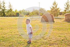 Summer, childhood and baby concept - little boy having fun in summer nature