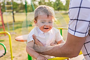 Summer, childhood, leisure and child concept - happy boy on children playground with his father