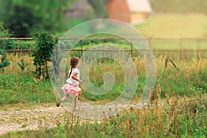 Summer, childhood, leisure and people concept - happy Cute little Girl is running on green summer park