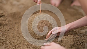 Summer, children hands play and build sand castles on beach