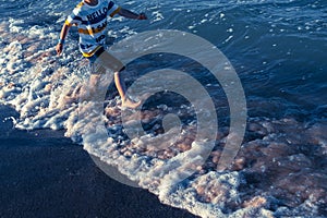 In summer children have to exercise outdoors and go out to sea to run alongside the waves