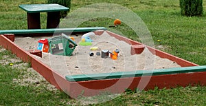 Summer children`s toys on the sand, a small sandbox. Latvia
