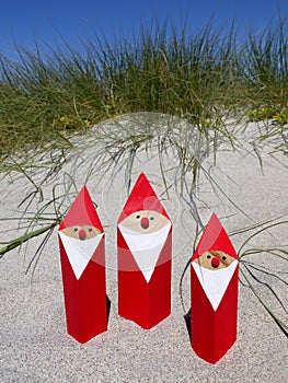 Summer Christmas: santas in sand photo