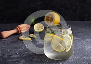 Summer citrus lemonade Alcohol cocktail Gin tonic with squeezed lemon and lemon reamer or juicer