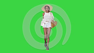 Summer in the city Beautiful african american woman wearing fashionable hat walking on a Green Screen, Chroma Key.