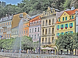 Summer street with old house, river and fountain in Karlovy Vary, Czech Republic