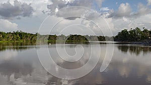 Summer cloudscape reflected on tranquil Eco Pond in Everglades National Park 4K.