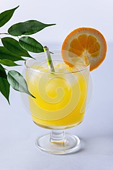 Summer cocktail Cold Orange Juice Healthy Yellow Drink Blue Background Vertical