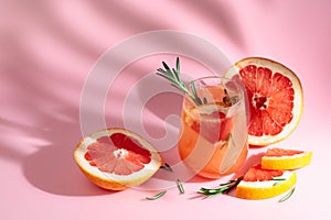 Summer cocktail with grapefruit, rosemary, and ice