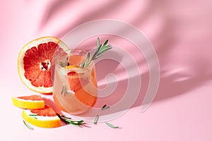 Summer cocktail with grapefruit, rosemary, and ice