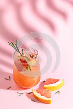 Summer cocktail with grapefruit, rosemary, and ice