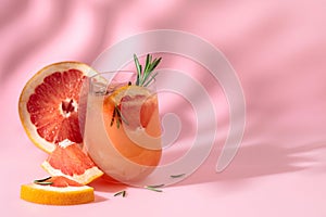 Summer cocktail with grapefruit, rosemary, and ice