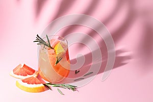 Summer cocktail with grapefruit, rosemary, and ice