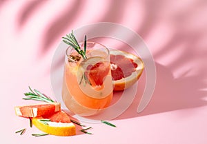 Summer cocktail with grapefruit, rosemary, and ice