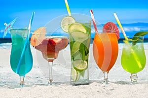 Summer cocktails drinks with beach on background