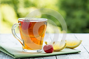 Summer cold cup of tea on a wooden table