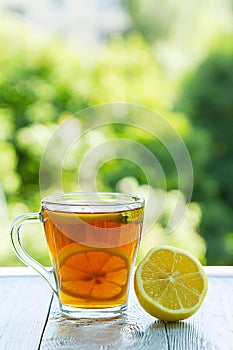 Summer cold cup of tea on a wooden table