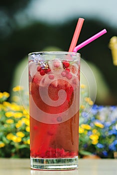 Summer cold drink outdoor. Red freshment drink with cowberry and fresh lavender at cafe terrace. Water detox with cowberry.