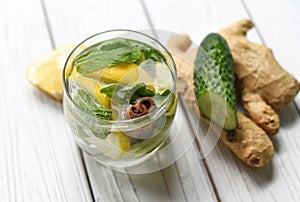 A summer cold refreshing healthy appetizing drink with water, lemon, ginger, mint leaves and cucumber