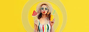 Summer colorful portrait of beautiful young woman blowing her lips with cup of juice and lollipop or ice cream shaped slice of