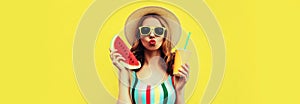 Summer colorful portrait of beautiful young woman blowing her lips with slice of watermelon and cup of juice wearing straw hat on