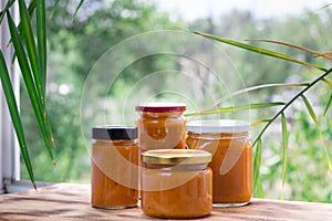 Summer composition of apricot jam cans cooked from fruit harvest