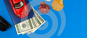 Summer composition banner with blue background, summer vacation concept with toy car and money, flat lay and top view