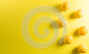 Summer composition made from lemon or lime on pastel yellow background. Fruit minimal concept. Flat lay, top view, copy space