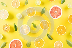 Summer composition made from oranges, lemon or lime on pastel yellow background. Fruit minimal concept. Flat lay, top view