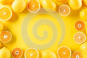 Summer composition made from oranges, lemon or lime on pastel yellow background. Fruit minimal concept. Flat lay, top view, copy