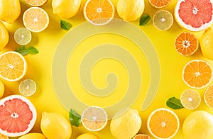 Summer composition made from oranges, lemon or lime on pastel yellow background. Fruit minimal concept. Flat lay, top view, copy