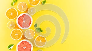 Summer composition made from oranges, lemon or lime on pastel yellow background. Fruit minimal concept. Flat lay, top view, copy