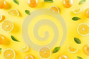 Summer composition made from oranges on pastel yellow background. Fruit minimal concept. Flat lay, top view, copy space