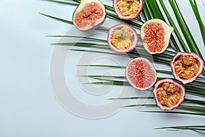 Summer composition with tropical fruits and palm leaf on white background