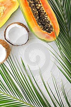 Summer composition with tropical fruits on white textured background