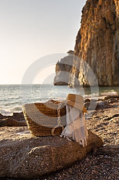 Summer concept. Woven basket with a straw hat and picnic blanket