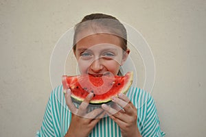 Summer concept with young girl eating a watermelon
