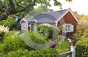 Summer cottage with flower in the garden