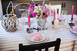 summer cottage kitchen decorated for festive dinner. Romantic table setting with candles
