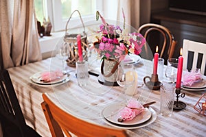 Summer cottage kitchen decorated for festive dinner. Romantic table setting with candles