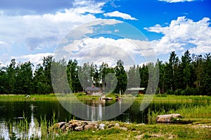 Summer cottage or log cabin by the blue lake in rural Finland.