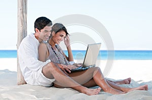 Summer couple using laptop