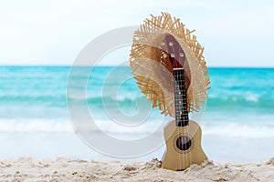 The Summer day with Guitar ukulele items travel for relax and chills on the beautiful beach and blue sky background,copy space. photo