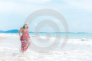 Summer Day. Smiling woman wearing fashion summer beach having fun playing splashing water