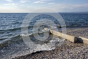 Summer day on stone beach in Izola town in Slovenia