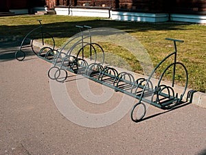 summer day, there are a lot of empty parking spaces for bicycles in the park