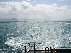 Summer day travelling by ferry boat ship. boat propeller wake foam water sea surface in wash blue