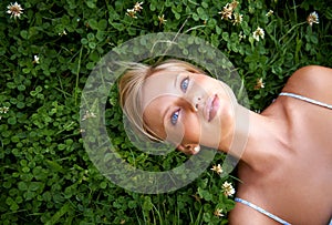 Summer daydreams. an attractive young woman lying on the grass.