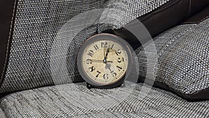 Summer Daylight Saving Time DST concept. Retro styled Clock with pillows