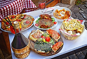 A summer dinner .Pasta , pizza and homemade food arrangement photo